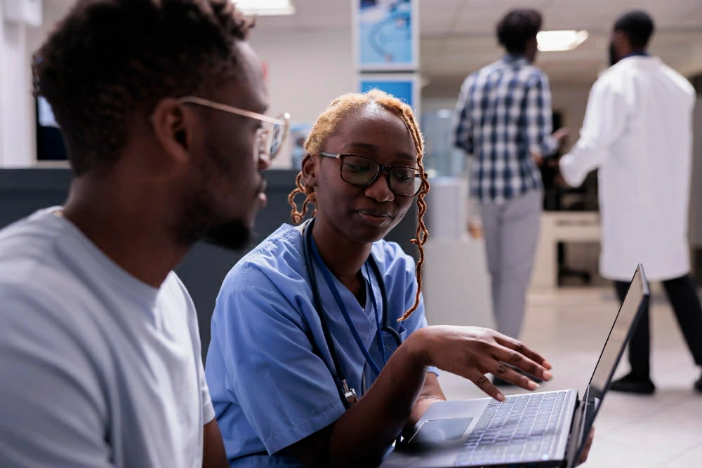 lady guiding male nurse with documents